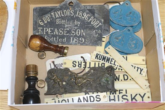 A collection of assorted cellar labels including ivorine and metal, five pierced metal stencils, a cast bronze plaque 17cm